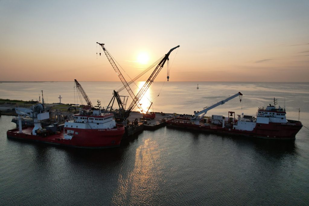 Offshore construction fleet at port with cranes